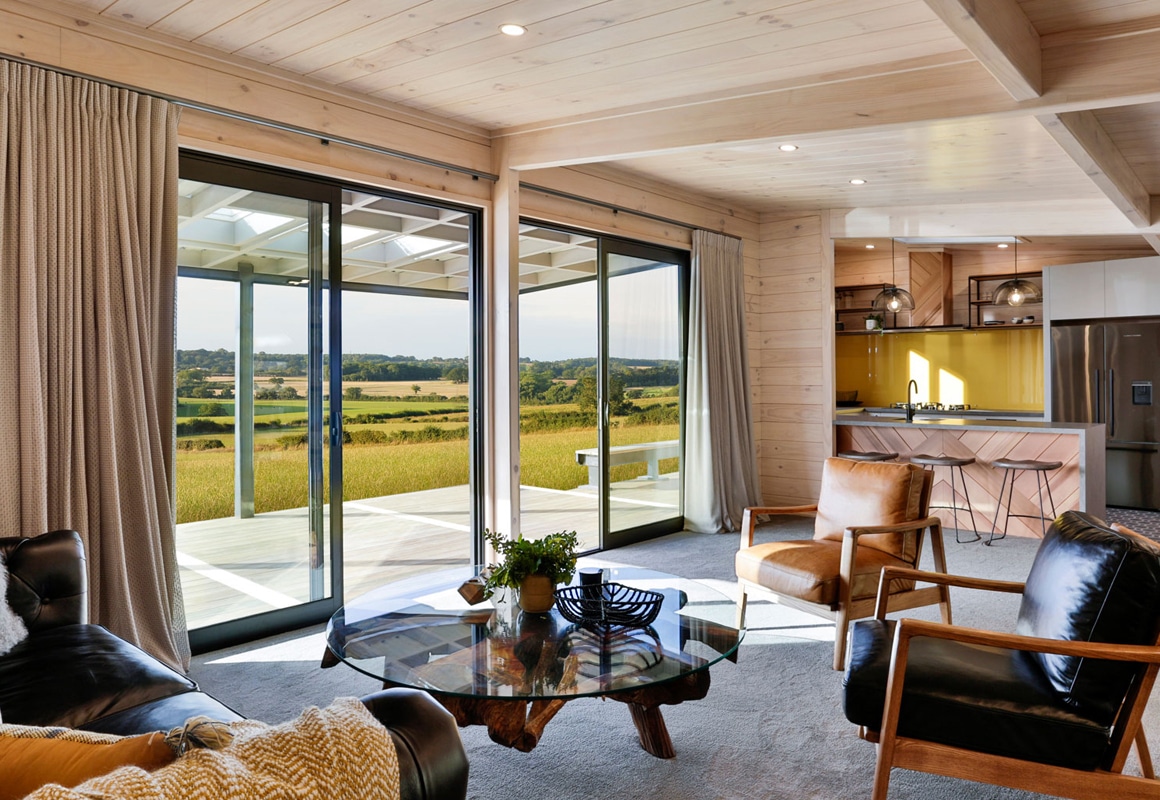brown curtains in modern lockwood lounge room on timber walls