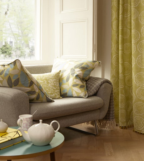 yellow and white dot circle pattern curtains in contemporary lounge room on white walls