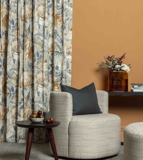 gold blue and grey floral pattern curtains in contemporary lounge on orange walls