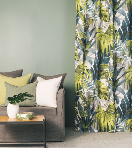 green blue teal leaf foliage pattern curtains in modern boho lounge room on mint green walls