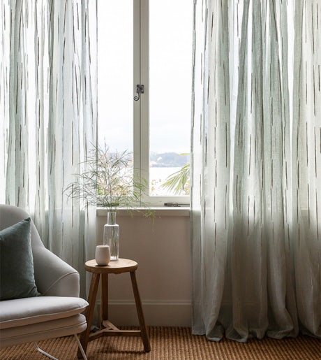 brown and white vertical line pattern sheer curtains in contemporary lounge on beige walls