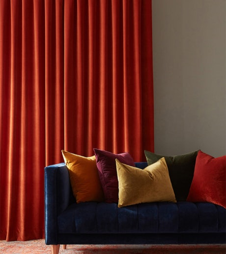 orange red curtains in contemporary lounge on grey walls