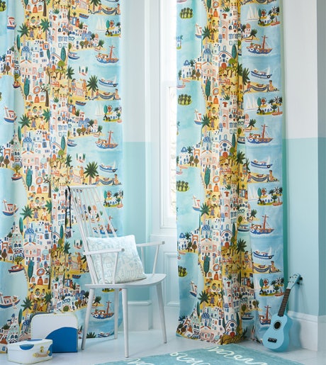 blue yellow and green island theme pattern curtains in modern beachy childrens room on pale blue walls