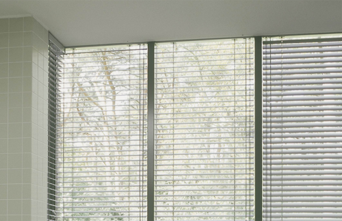 Aluminium venetian blinds on window
