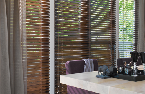 timber wood venetian blinds and beige curtains in contemporary kitchen on white walls