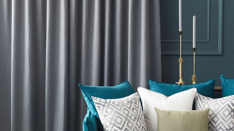 Dark grey curtains on green wall in lounge room