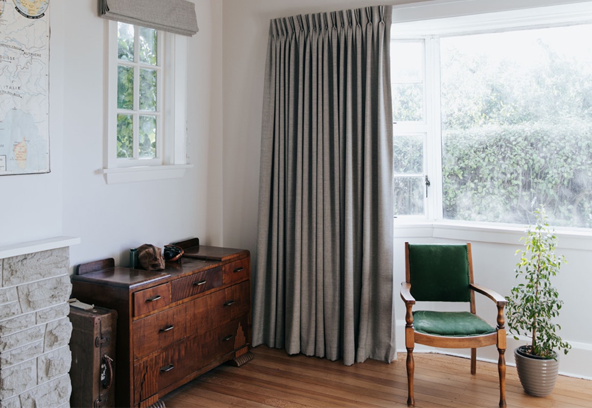 grey curtains in contemporary lounge room on white walls