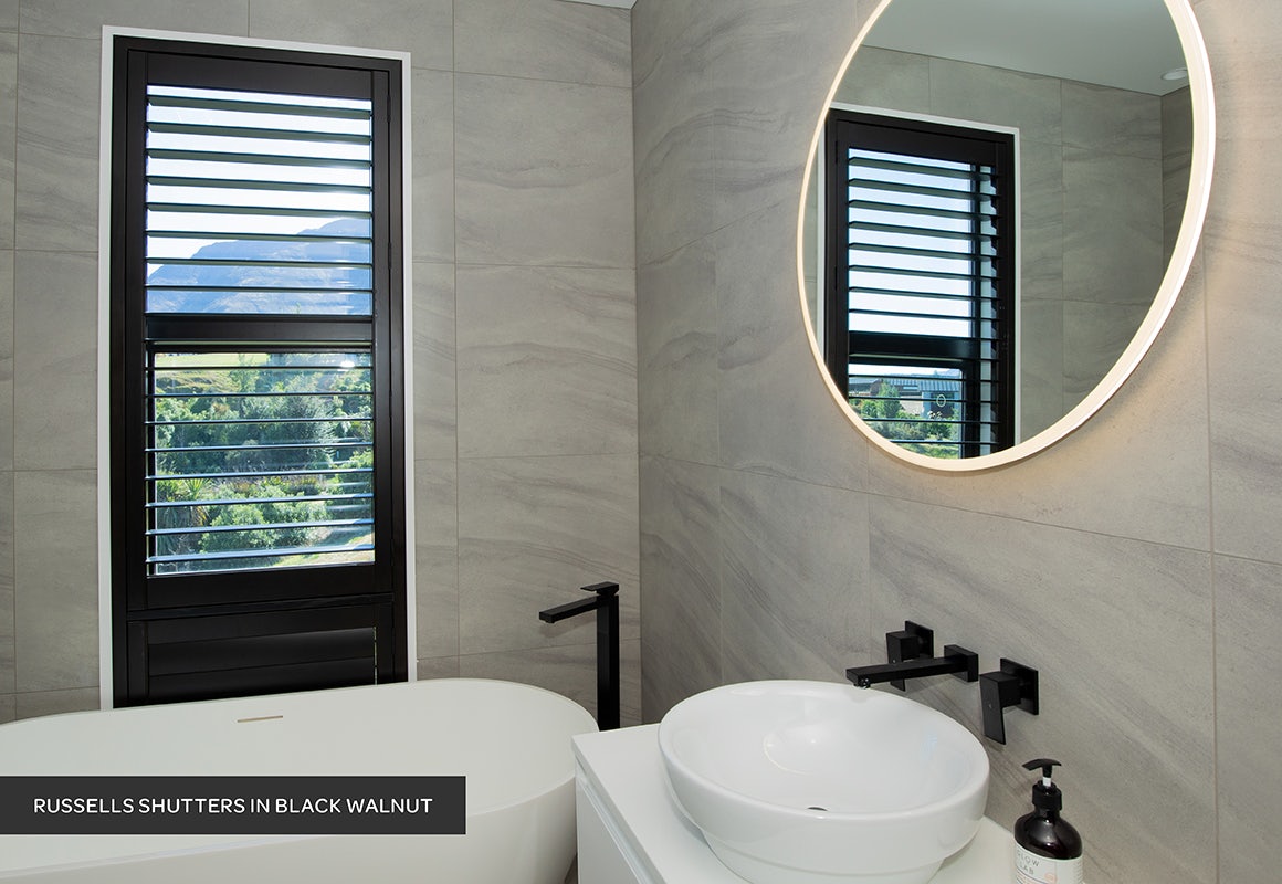 black timber shutters in modern minimal bathroom on grey pattern tiles