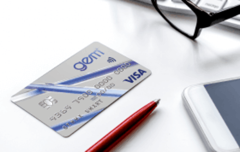 visa credit card on desk with pen phone glasses keyboard