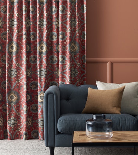 Red and navy blue patterned curtains in contemporary lounge on rust orange walls
