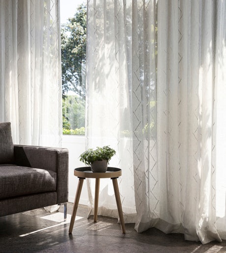 white zig zag texture pattern sheer curtains in contemporary lounge room with plant