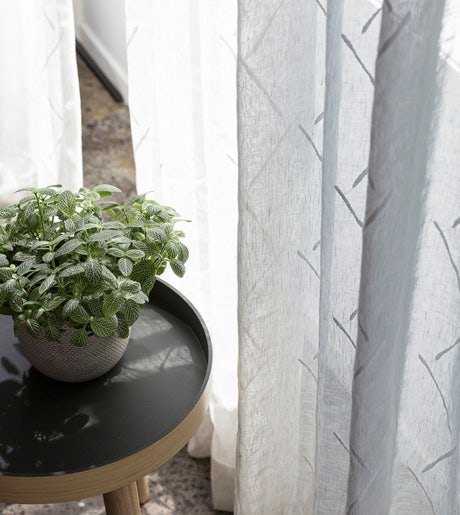 grey diagonal line pattern sheer curtains with plant