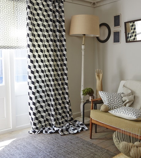 black and white geometric cube patten curtains in contemporary lounge room on white walls