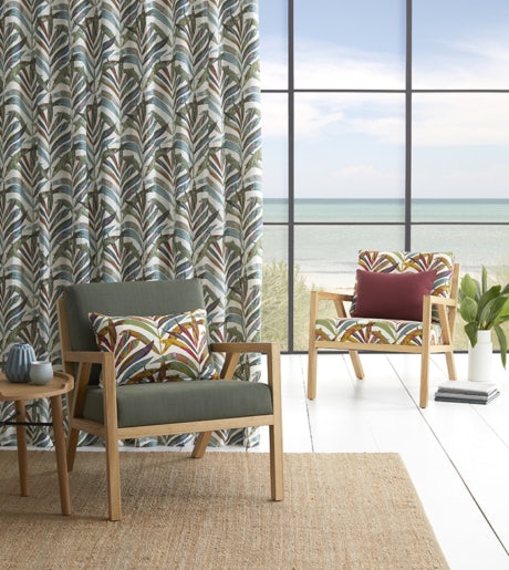 blue green white eucalyptus leaf foliage pattern curtains in modern boho lounge room on white timber floors