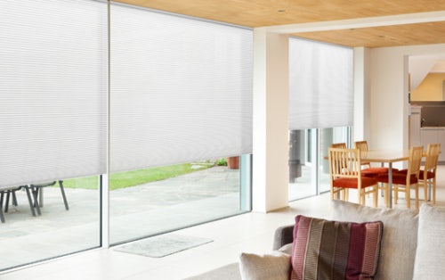 white honey comb blinds in modern lounge room on large windows
