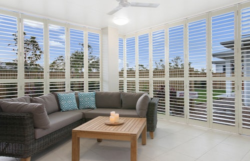 white shutters in indoor outdoor area on white walls