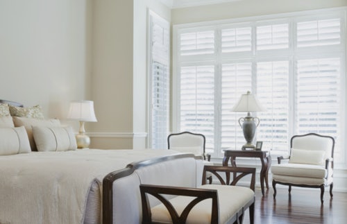white shutters in victorian bedroom on white walls