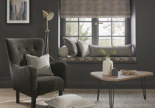 concrete grey roman blinds in moody modern lounge room on brown grey walls