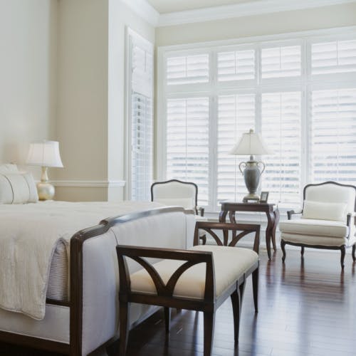 white timber wood shutters in traditional luxury bedroom on white walls