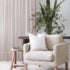 White wall living room, Light pink sheer curtain in lounge room with armchair and plant