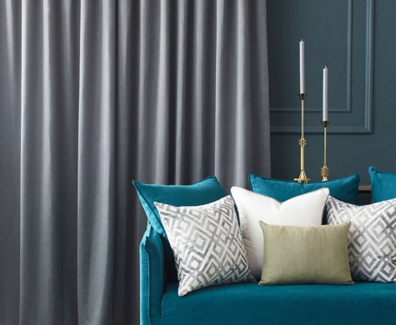 Living room with grey curtains nz on teal wall