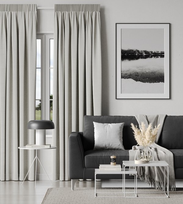 Cream-coloured pencil pleat curtains in a modern living room.