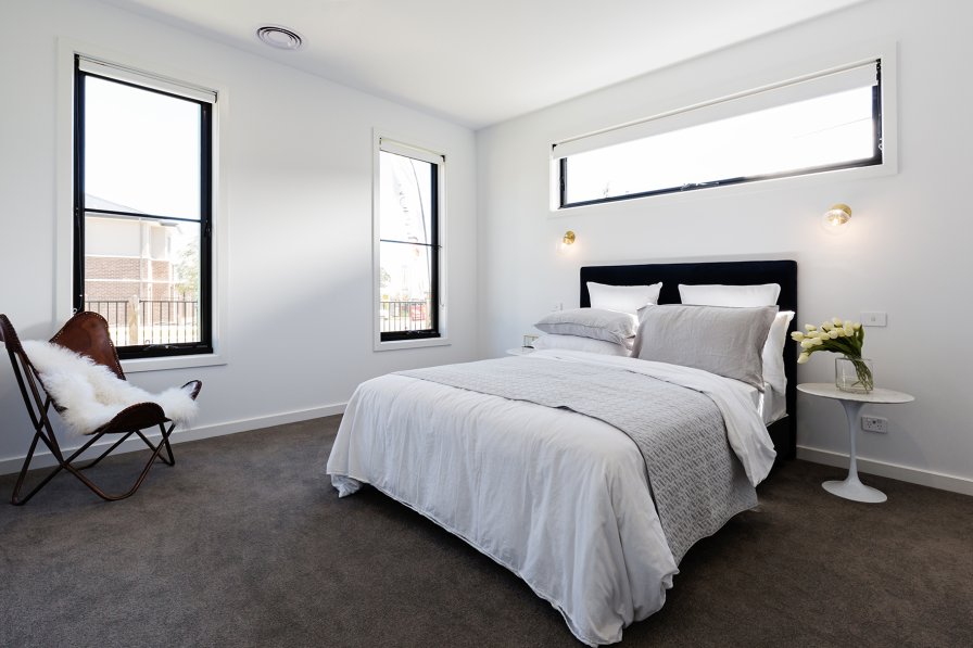 Roller blind in a neutral fabric filtering natural light at a window