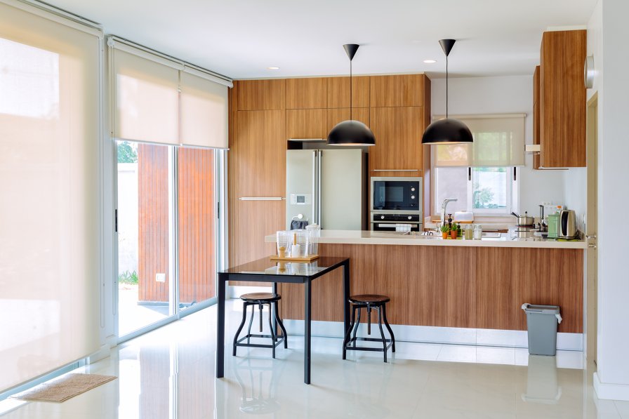 Floor to ceiling curtains drawing the eye up in a compact room
