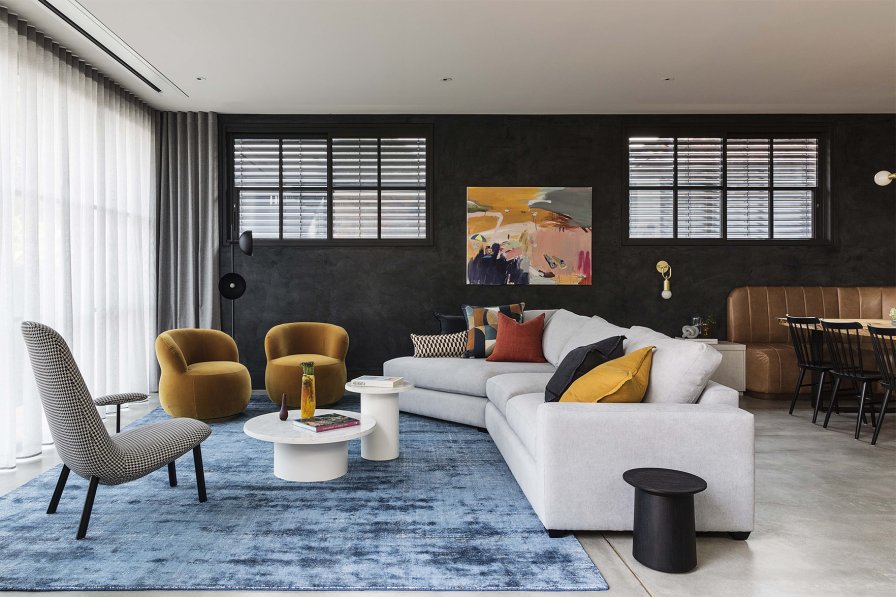 Modern living room with vertical striped white and dark grey sheer curtains.