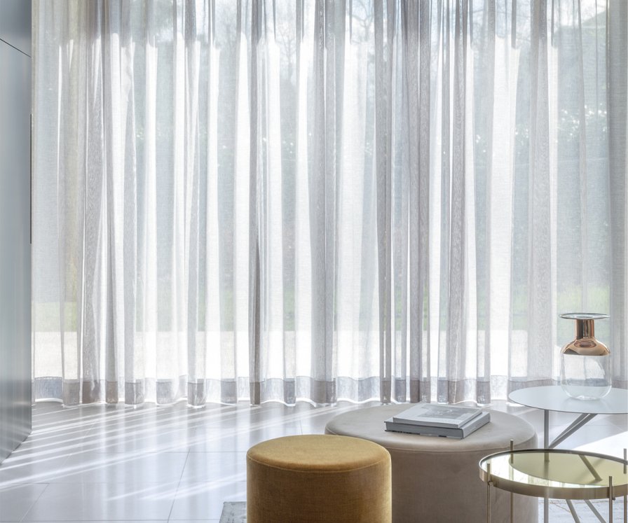 Full height curtains in a light-filled living space
