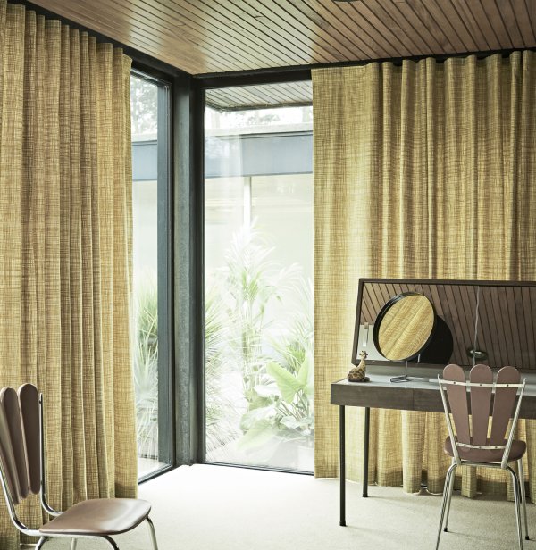 Olive-green striped curtains on corner windows in a minimalist modern space.