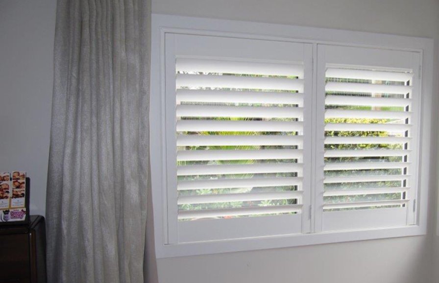 White timber plantation shutters on a living room window