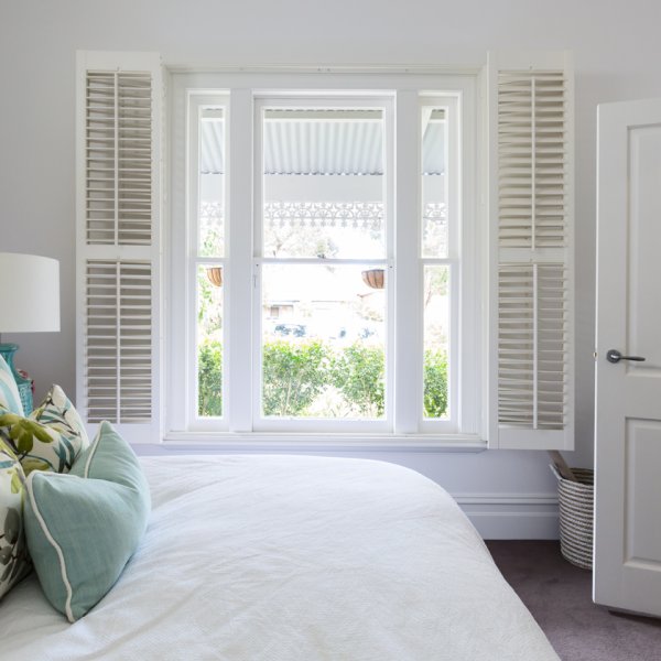 Plantation shutters styled in a living room with natural decor