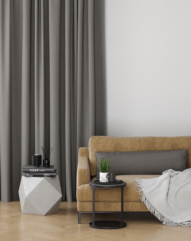 Stone-coloured pinch pleat curtains beside a mustard and tan upholstered armchair.