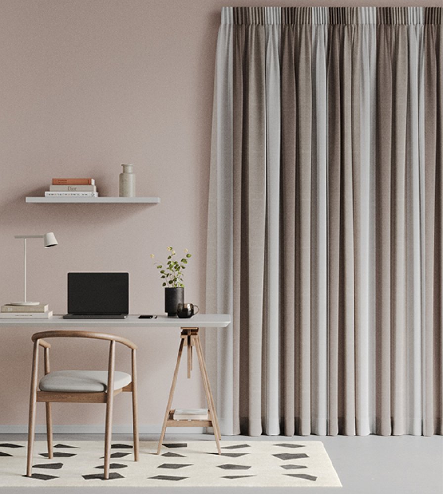 Pale grey linen curtains beside a home-office desk with a laptop and a potted plant.