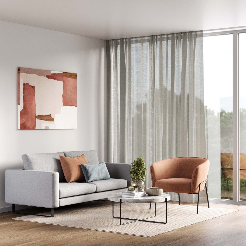 Pale grey layered curtains in a modern living room with grey and orange chairs.