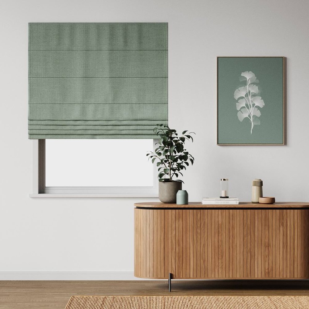 Black roller blind on a modern apartment window overlooking a city skyline.