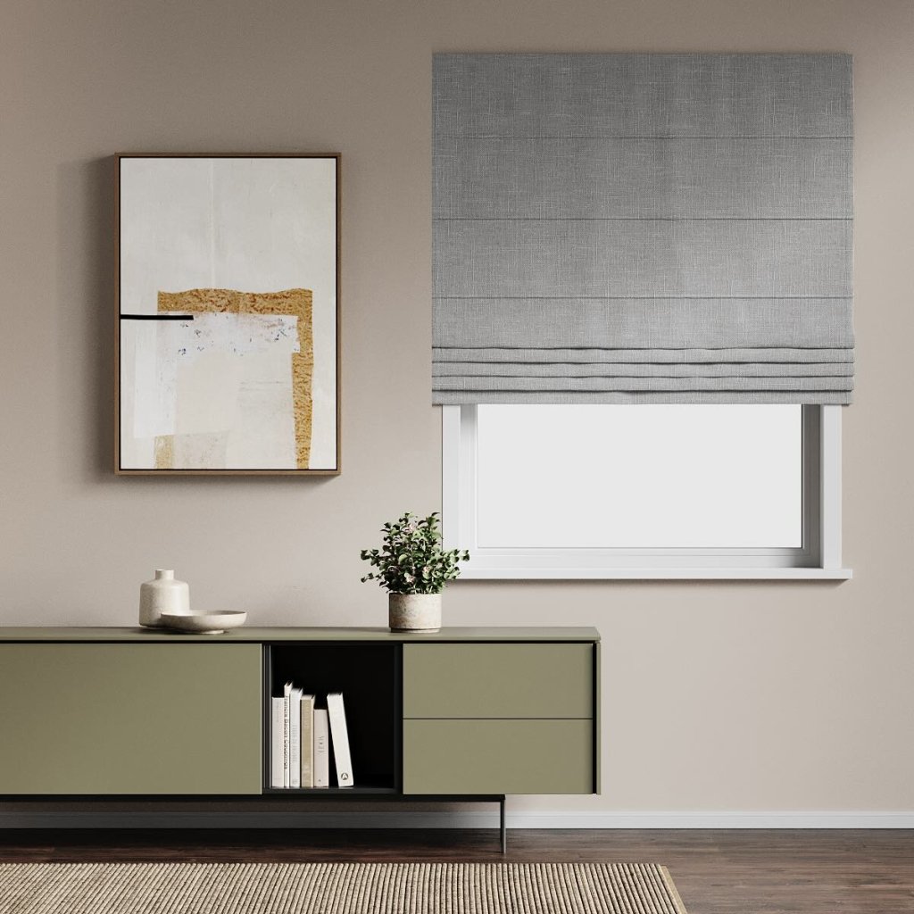 Grey pleated roman blind on a window in a modern lounge.