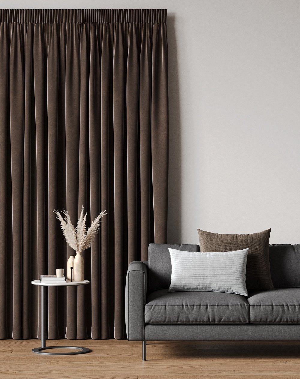 Taupe pencil pleat curtains beside a grey sofa with taupe cushions and a white lamp.