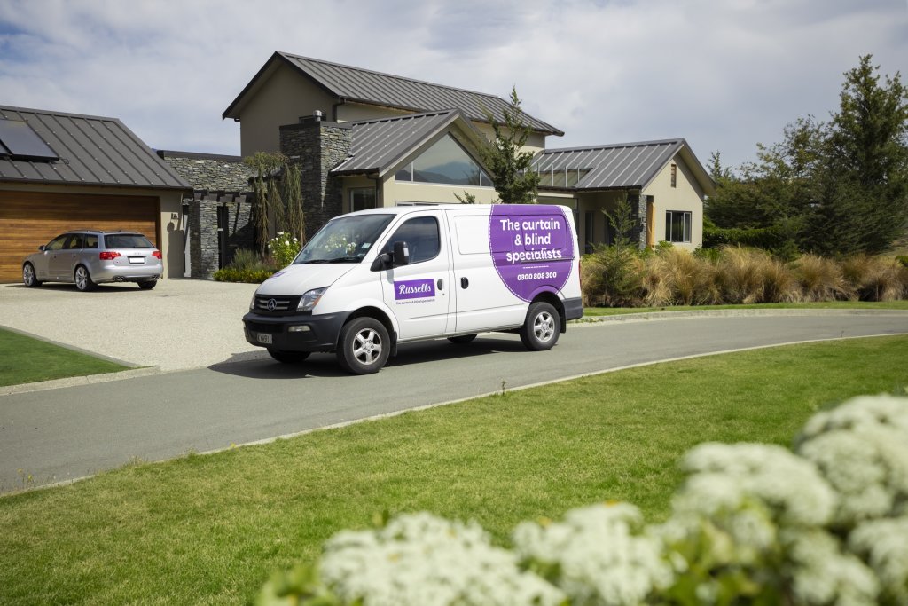 A Russells curtain and blind specialists van parked in the driveway of a modern home, ready for an in-home consultation.
