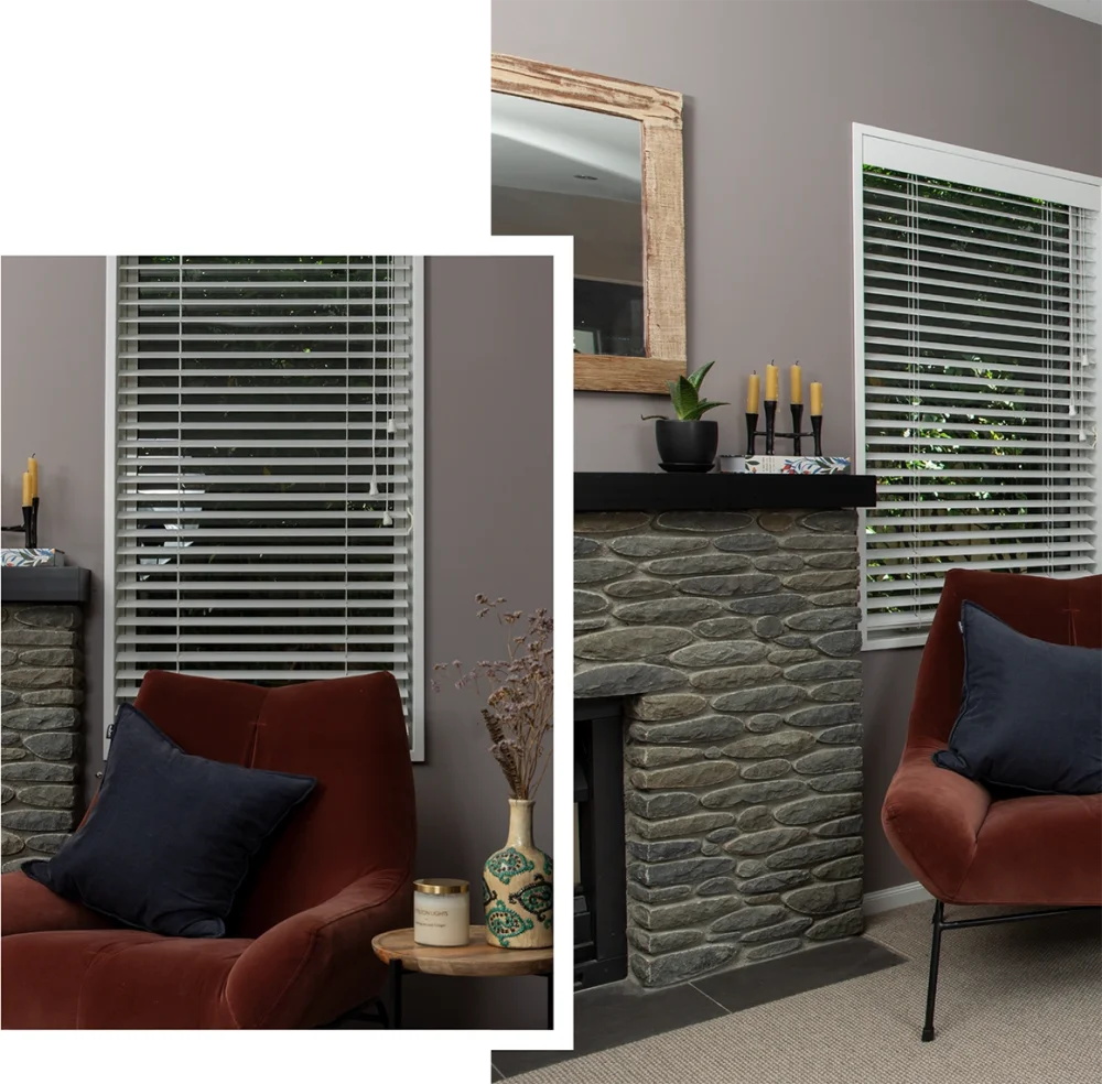 Black horizontal blinds in a bedroom with a burgundy armchair and wooden furniture.