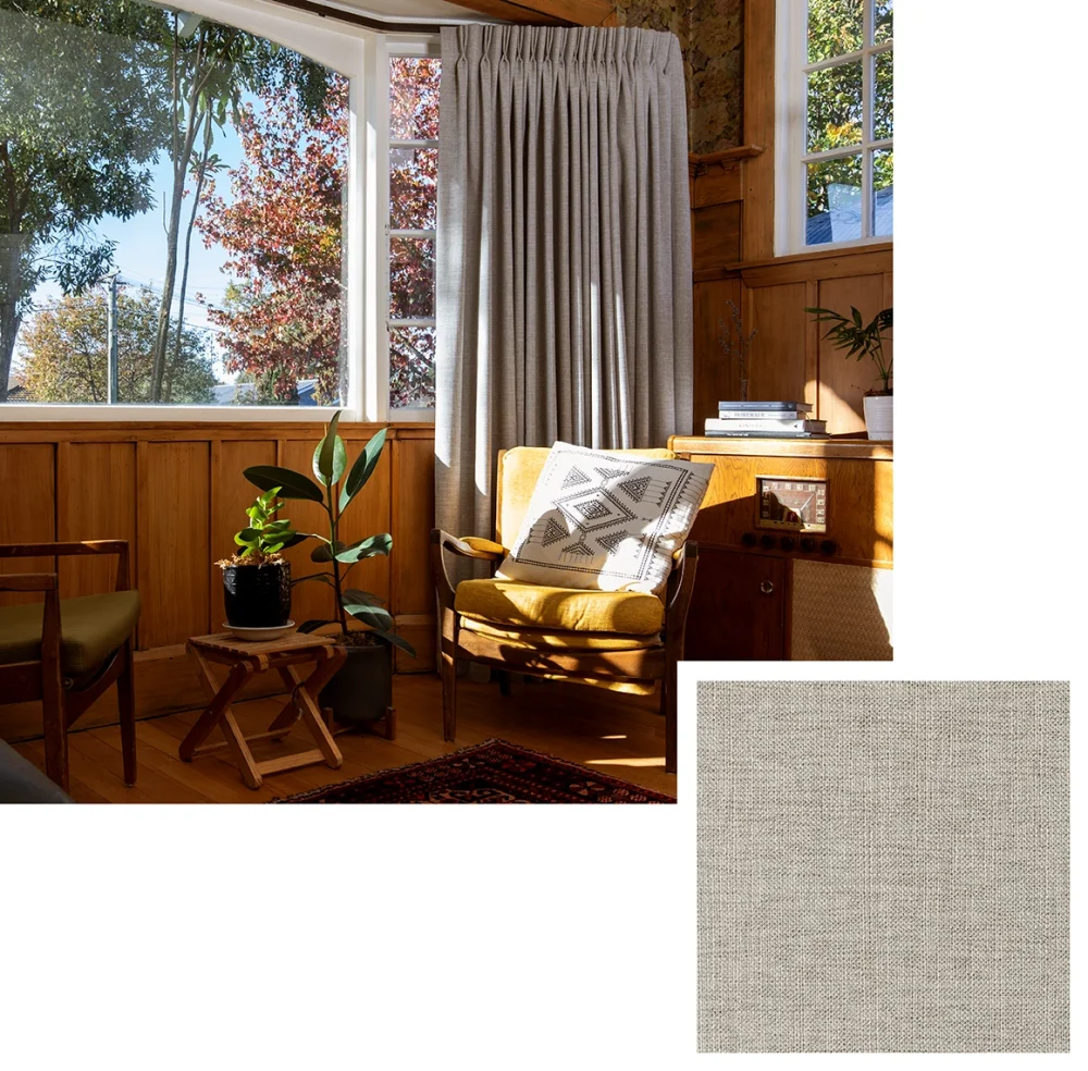 Pale linen curtains in a timber-lined bedroom with autumn trees visible outside.