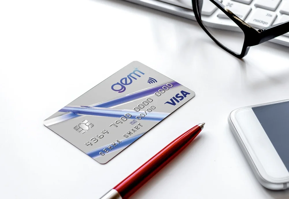 A Russells Gem finance card on a desk with glasses and a pen.