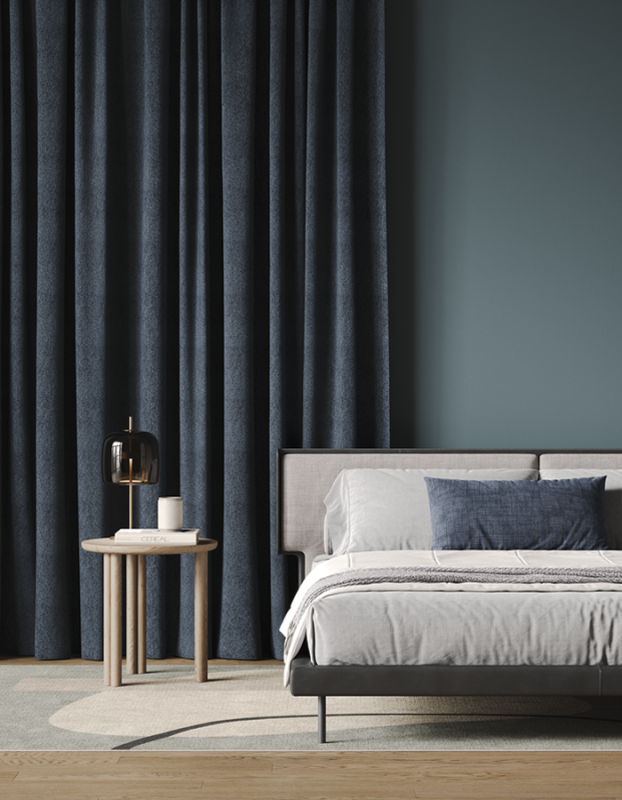 Deep navy textured linen curtains beside a bed.
