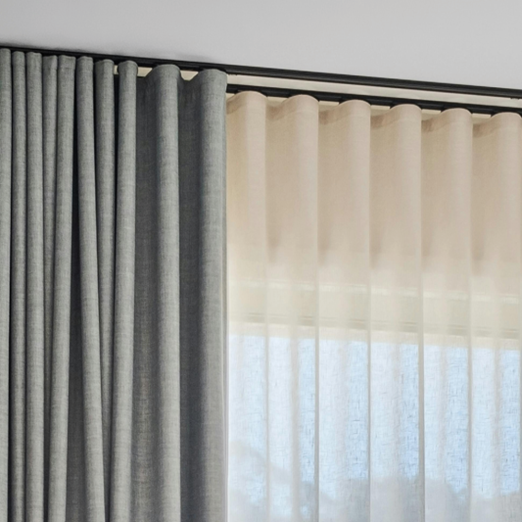 Grey curtains showing the smooth, even waves of an s-fold heading style.