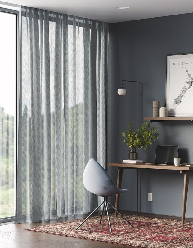 Pale grey striped sheer curtains in a home office with a wooden desk and chair.